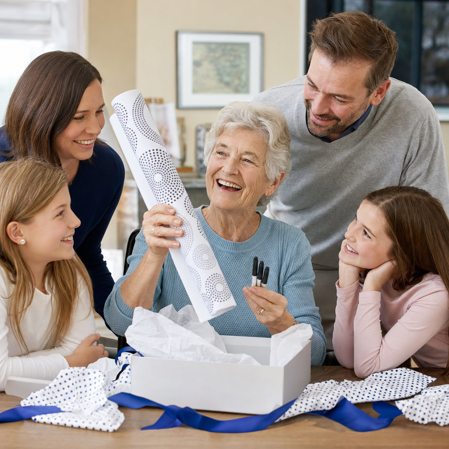 A grandmother unwrapping an Own Photo dot painting kit with her family